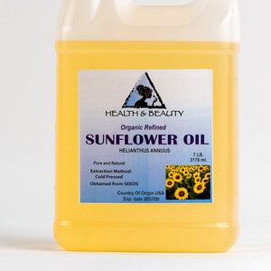 May include: A gallon jug of organic refined sunflower oil, labeled "Health & Beauty" with the text "Sunflower Oil" and "Helianthus Annuus". The label also states "Pure and Natural", "Extraction Method: Cold Pressed", "Obtained from SEEDS", "Country of Origin USA", and "Exp. date". The jug is filled with a yellow liquid and has a white cap.