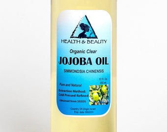 May include: A clear glass bottle of 12 fluid ounce (355 ml) organic jojoba oil. The label is blue and white with the text "HEALTH & BEAUTY Organic Clear JOJOBA OIL SIMMONDSIA CHINENSIS Pure and Natural Extraction Method: Cold Pressed Refined Obtained from SEEDS Country Of Origin Israel Exp. date".