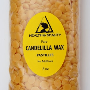 May include: A clear plastic bag filled with yellow candelilla wax pastilles. The bag has a yellow label with the text "HEALTH & BEAUTY", "Pure", "CANDELILLA WAX", "PASTILLES", "No Additives", and "8 oz".