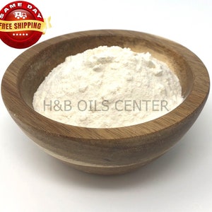 May include: A white powder in a wooden bowl. The bowl is on a white background. The text "H&B OILS CENTER" is visible on the powder.