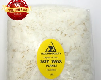 May include: A clear plastic bag filled with white soy wax flakes. The bag has a yellow label that reads "Health & Beauty Organic & Pure Soy Wax Flakes No Additives 2 LB".