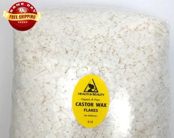 May include: A clear plastic bag filled with white castor wax flakes. The bag has a yellow label that reads "HEALTH & BEAUTY Organic & Pure CASTOR WAX FLAKES No Additives 8 LB".