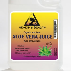 May include: A clear plastic bottle with a yellow label that reads "HEALTH & BEAUTY Organic and Pure ALOE VERA JUICE ALOE BARBADENSIS All Natural Extraction Method: Leaf Processing Obtained from LEAF Country Of Origin Canada 7 LB. 3178 ml."