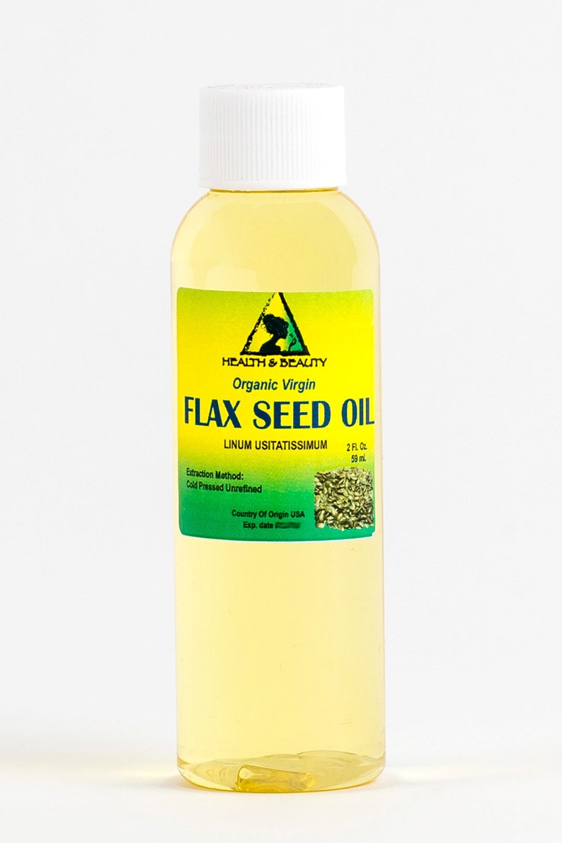 May include: A clear glass bottle with a white cap containing organic virgin flax seed oil. The label is yellow with green text and a green image of flax seeds. The label reads "HEALTH & BEAUTY", "Organic Virgin", "FLAX SEED OIL", "LINUM USITATISSIMUM", "2 FL OZ", "59 ml", "Extraction Method: Cold Pressed Unrefined", "Country Of Origin USA", "Exp. date".