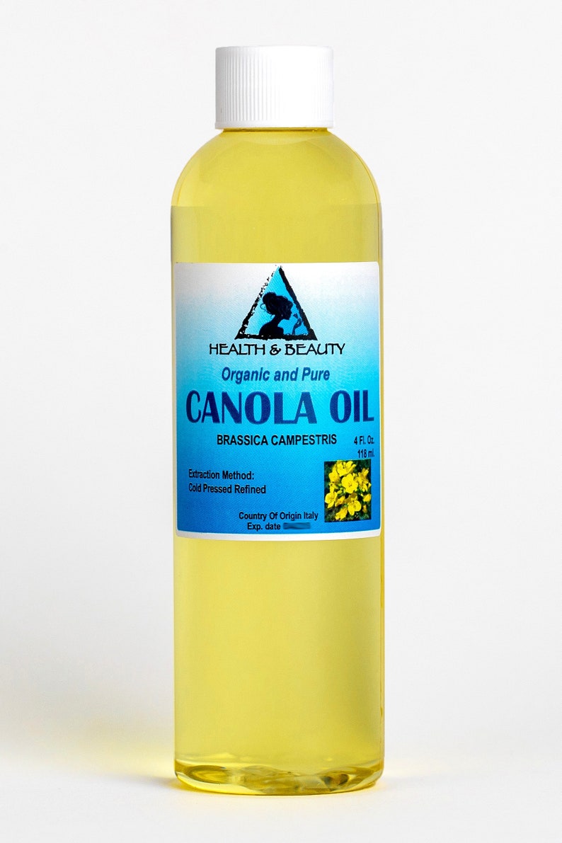 May include: A clear glass bottle with a white cap filled with yellow canola oil. The label is blue and white and reads "HEALTH & BEAUTY Organic and Pure CANOLA OIL BRASSICA CAMPESTRIS 4 FL. Oz 118 ml Extraction Method: Cold Pressed Refined Country Of Origin Italy Exp. date"