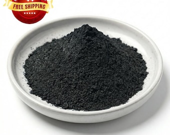 May include: A white ceramic bowl filled with a mound of fine, black powder. The powder has a granular texture and is piled high in the center of the bowl. A red and yellow banner with the words "SAME DAY FREE SHIPPING" is in the upper left corner.