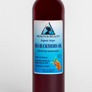 May include: A glass bottle of organic virgin sea buckthorn oil, labeled "Health & Beauty", with a blue and white label featuring a woman's silhouette and the text "Sea Buckthorn Oil", "Hippophae Rhamnoides", "Pure and Natural", "Extraction Method: Supercritical CO2", "Obtained from FRUIT", "Country of Origin USA", and "Exp. date".