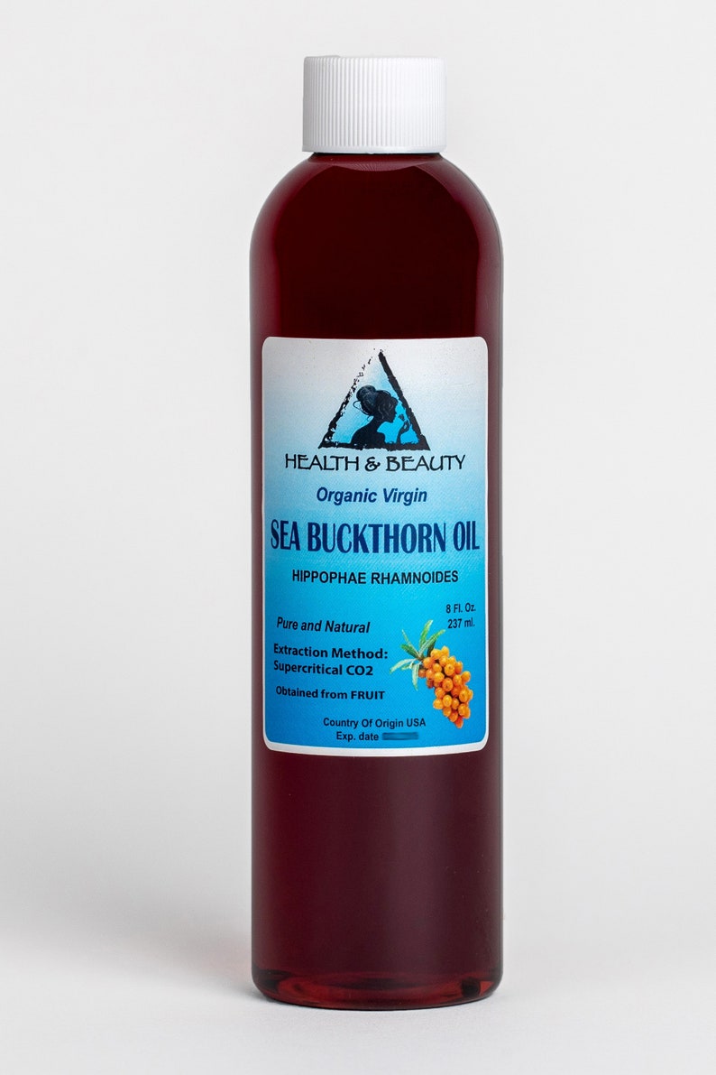 May include: A glass bottle of organic virgin sea buckthorn oil, labeled "Health & Beauty", with a blue and white label featuring a woman's silhouette and the text "Sea Buckthorn Oil", "Hippophae Rhamnoides", "Pure and Natural", "Extraction Method: Supercritical CO2", "Obtained from FRUIT", "Country of Origin USA", and "Exp. date".