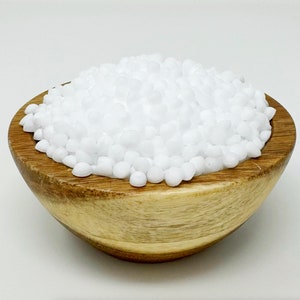 May include: A wooden bowl filled with small, white, round beads.