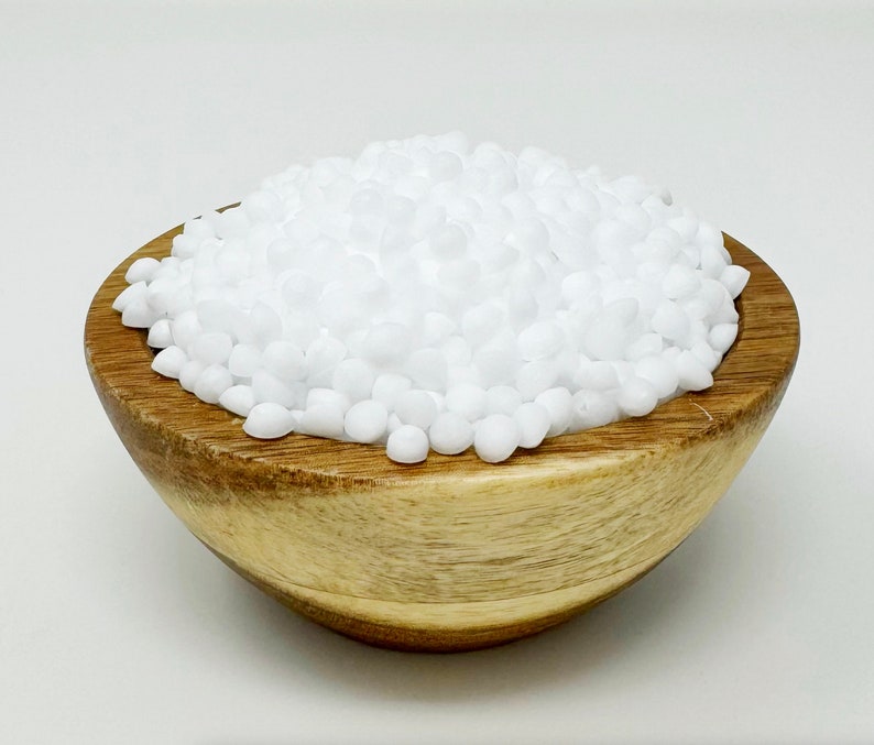 May include: A wooden bowl filled with small, white, round beads.