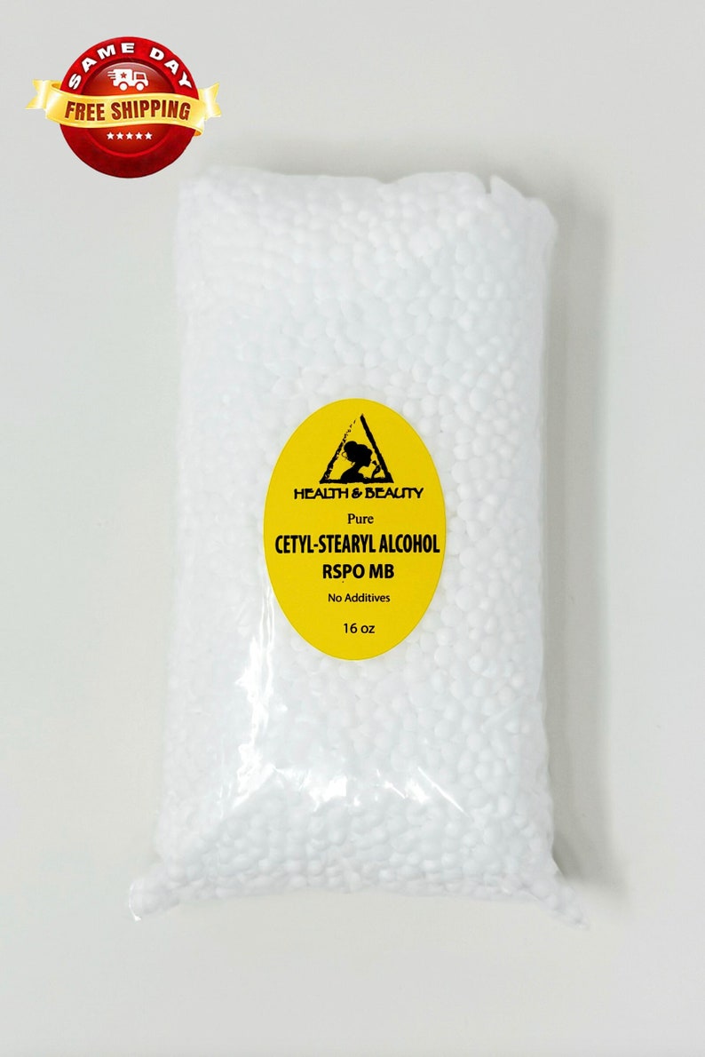 May include: A white plastic bag filled with white beads. The bag has a yellow label with black text that reads "HEALTH & BEAUTY Pure CETYL-STEARYL ALCOHOL RSPO MB No Additives 16 oz".