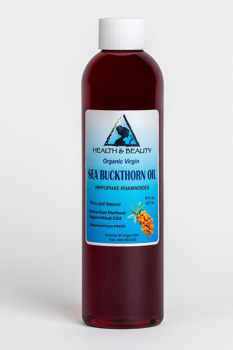 May include: A clear glass bottle with a white cap filled with a dark red liquid. The label is blue and white and says "HEALTH & BEAUTY Organic Virgin SEA BUCKTHORN OIL HIPPOPHAE RHAMNOIDES Pure and Natural 8 Fl. Oz. 237 ml Extraction Method: Supercritical CO2 Obtained from FRUIT Country Of Origin USA Exp. date"
