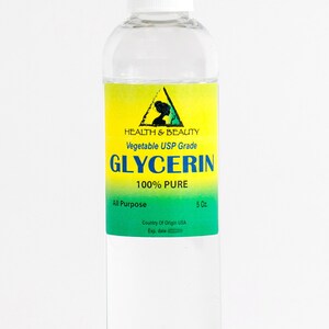 May include: A clear glass bottle with a white cap, containing a liquid. The label is yellow with a green triangle and the text "HEALTH & BEAUTY Vegetable USP Grade GLYCERIN 100% PURE All Purpose Country Of Origin USA 5 Oz. Exp. date"