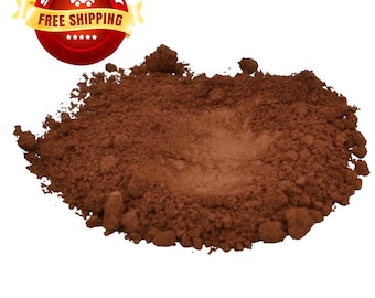 May include: A pile of brown powder, likely cocoa powder, on a white background.