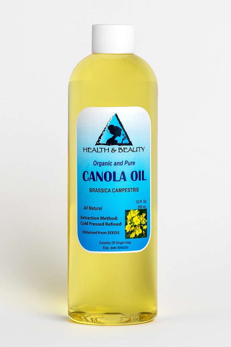 May include: A clear glass bottle of organic and pure canola oil, labeled "HEALTH & BEAUTY CANOLA OIL BRASSICA CAMPESTRIS", with a yellow flower graphic and the text "All Natural 12 Fl. Oz 355 ml Extraction Method: Cold Pressed Refined Obtained from SEEDS Country Of Origin Italy Exp. date"
