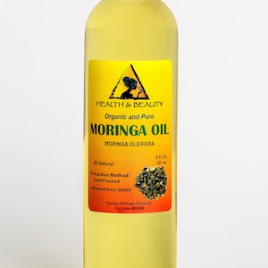 May include: A clear glass bottle with a yellow label containing 8 fluid ounces of organic and pure Moringa Oil. The label features a triangle with a silhouette of a woman and the text "HEALTH & BEAUTY". The label also includes the text "Moringa Oleifera" and "Extraction Method: Cold Pressed".