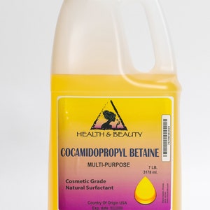 May include: A yellow plastic jug with a white cap and a label that reads "HEALTH & BEAUTY COCAMIDOPROPYL BETAINE MULTI-PURPOSE Cosmetic Grade Natural Surfactant Country Of Origin USA Exp. date 7 LB. 3178 ml."