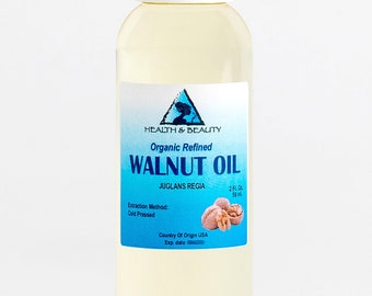 May include: A clear glass bottle with a white cap, containing organic refined walnut oil. The label is blue and white with the text "HEALTH & BEAUTY", "Organic Refined WALNUT OIL", "JUGLANS REGIA", "2 Fl. Oz 59 ml", "Extraction Method: Cold Pressed", "Country Of Origin USA", and "Exp. date".