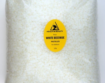 May include: A clear plastic bag filled with white beeswax pastilles. The bag has a yellow label that reads "HEALTH & BEAUTY Pure WHITE BEESWAX PASTILLES No Additives 5 lb".
