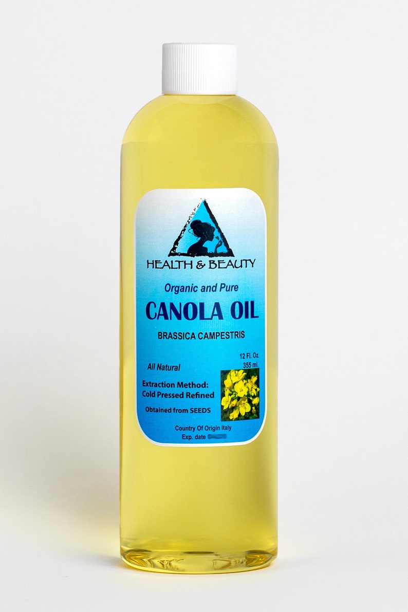 May include: A clear glass bottle of organic and pure canola oil, labeled "HEALTH & BEAUTY CANOLA OIL BRASSICA CAMPESTRIS", with a yellow flower graphic and the text "All Natural 12 Fl. Oz 355 ml Extraction Method: Cold Pressed Refined Obtained from SEEDS Country Of Origin Italy Exp. date"