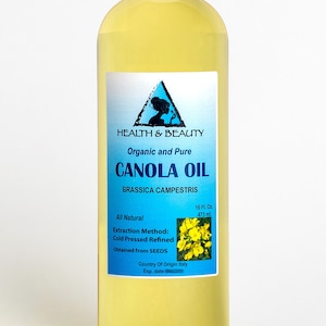 May include: A clear glass bottle of organic and pure canola oil, labeled "HEALTH & BEAUTY CANOLA OIL BRASSICA CAMPESTRIS", with a yellow flower image and the text "All Natural Extraction Method: Cold Pressed Refined Obtained from SEEDS Country Of Origin Italy Exp. date" on the label.