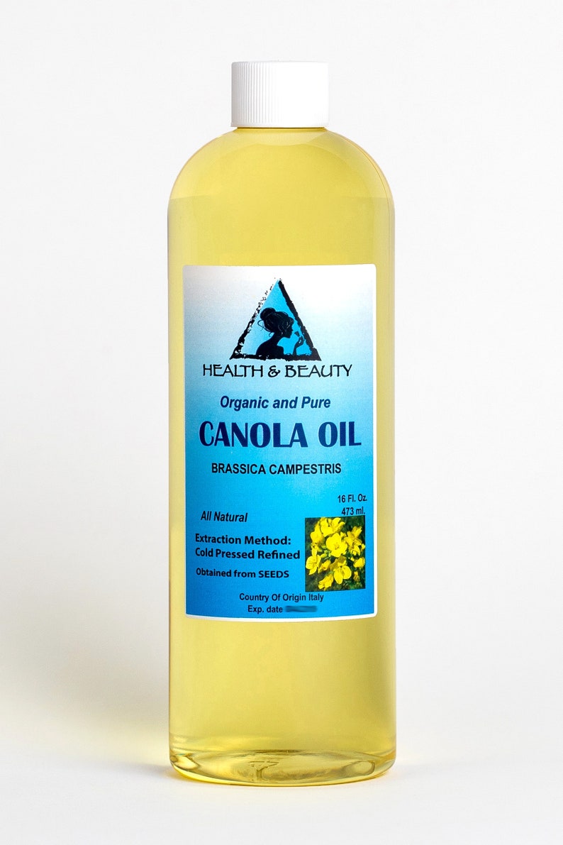 May include: A clear glass bottle of organic and pure canola oil, labeled "HEALTH & BEAUTY CANOLA OIL BRASSICA CAMPESTRIS", with a yellow flower image and the text "All Natural Extraction Method: Cold Pressed Refined Obtained from SEEDS Country Of Origin Italy Exp. date" on the label.