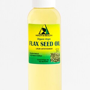 May include: A clear glass bottle with a white cap containing organic virgin flax seed oil. The label is yellow with green text and a green image of flax seeds. The label reads "HEALTH & BEAUTY", "Organic Virgin", "FLAX SEED OIL", "LINUM USITATISSIMUM", "2 FL OZ", "59 ml", "Extraction Method: Cold Pressed Unrefined", "Country Of Origin USA", "Exp. date".