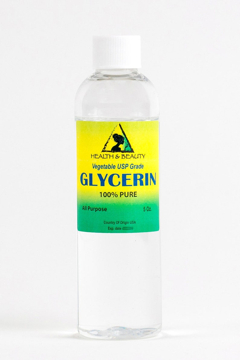 May include: A clear glass bottle with a white cap, containing a liquid. The label is yellow with a green triangle and the text "HEALTH & BEAUTY Vegetable USP Grade GLYCERIN 100% PURE All Purpose Country Of Origin USA 5 Oz. Exp. date".