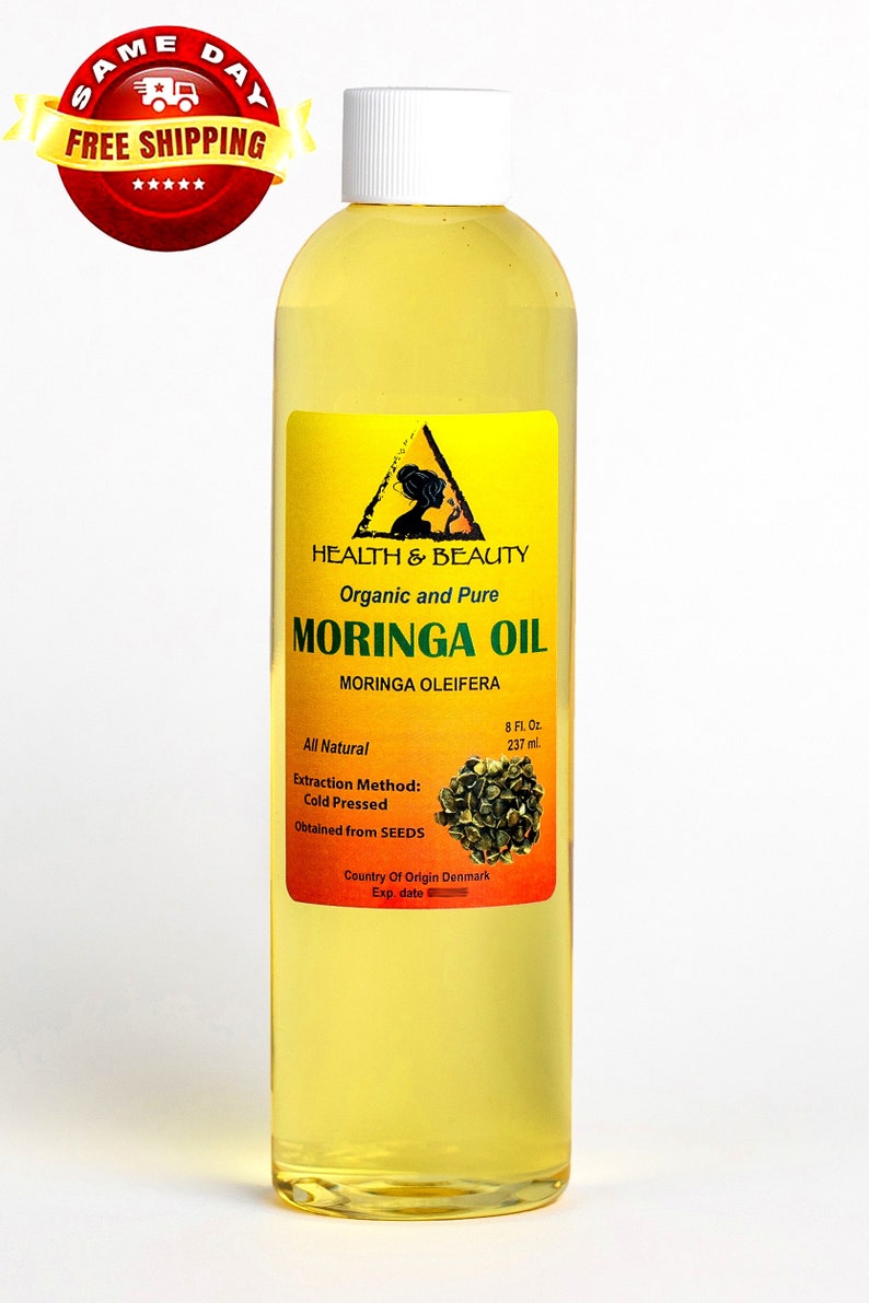 May include: A clear glass bottle with a white cap containing 8 fluid ounces of organic and pure Moringa Oil. The label is yellow and red with the text "HEALTH & BEAUTY", "Organic and Pure", "MORINGA OIL", "MORINGA OLEIFERA", "All Natural", "Extraction Method: Cold Pressed", "Obtained from SEEDS", "Country Of Origin Denmark", and "Exp date".