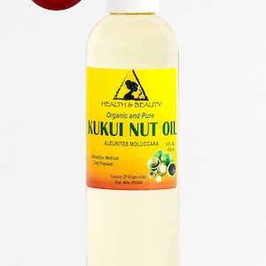 May include: A clear glass bottle with a yellow label containing organic and pure Kukui Nut Oil. The label features a triangle with a woman's silhouette and the text "Health & Beauty". The bottle is 4 fluid ounces (118 ml) and the oil is cold pressed. The country of origin is India.
