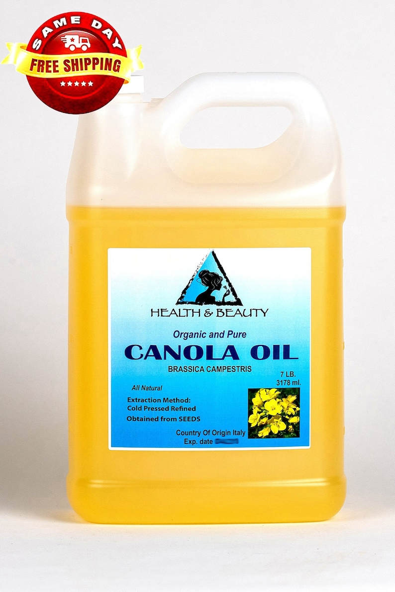 May include: A yellow plastic jug of organic and pure canola oil, labeled "Health & Beauty" with a triangle logo. The label also states "All Natural", "Extraction Method: Cold Pressed Refined", "Obtained from SEEDS", "Country of Origin Italy", "Exp. date", "7 LB. 3178 ml.", and features a small image of yellow canola flowers.