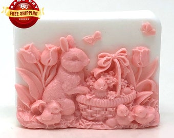 May include: Pink bunny rabbit soap with a basket of eggs, tulips, and butterflies. The soap is in a white rectangular shape.