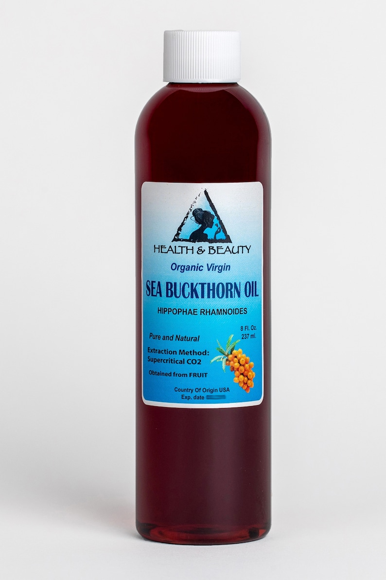 May include: A glass bottle of organic virgin sea buckthorn oil, labeled "Health & Beauty", with a blue and white label featuring a woman's silhouette and the text "Sea Buckthorn Oil", "Hippophae Rhamnoides", "Pure and Natural", "Extraction Method: Supercritical CO2", "Obtained from FRUIT", "Country of Origin USA", and "Exp. date".