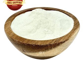 May include: A wooden bowl filled with a white powder. The powder is a light beige colour and has a smooth texture.