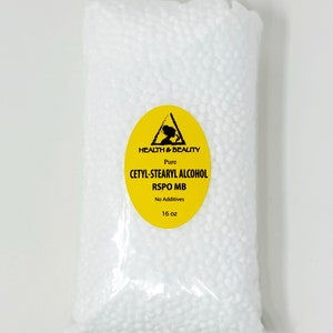 May include: A clear plastic bag filled with white beads. The bag has a yellow label with a black triangle and the text "HEALTH & BEAUTY Pure CETYL-STEARYL ALCOHOL RSPO MB No Additives 16 oz".
