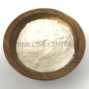 May include: A white powder in a wooden bowl. The bowl is labeled "H&B Oils Center".