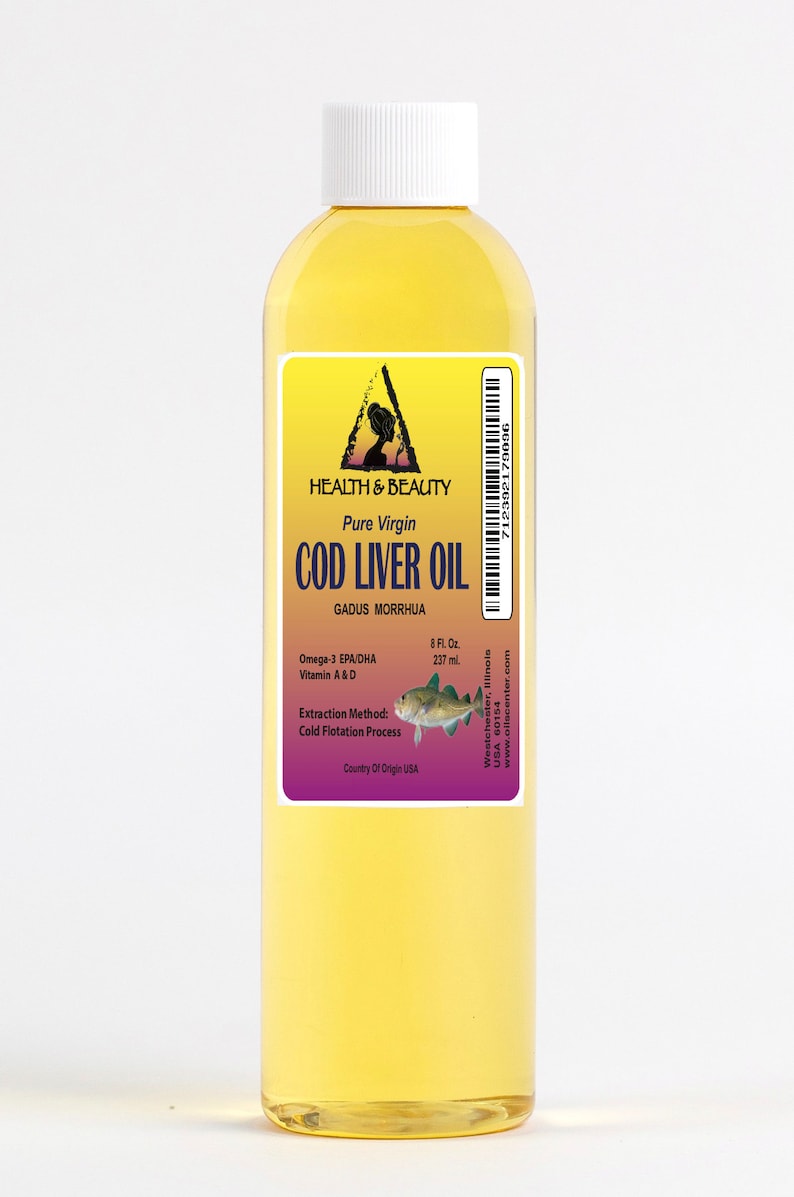 May include: A clear glass bottle of pure virgin cod liver oil with a yellow label. The label features a triangle with a woman's silhouette inside, the words "Health & Beauty", and the text "Pure Virgin Cod Liver Oil". The label also includes the scientific name for cod, "Gadus Morrhua", and information about the oil's omega-3 fatty acids, vitamins A and D, extraction method, and country of origin.