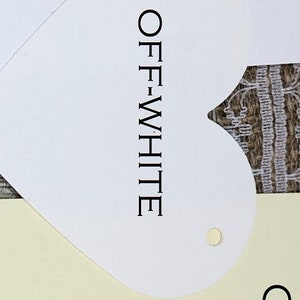 May include: Two paint colour swatches, one labelled "WHITE" and the other labelled "OFF-WHITE" in a heart shape. The swatches are on a cream background.