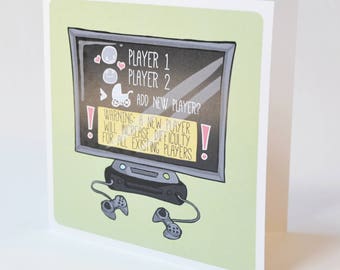 May include: A green card with a cartoon illustration of a video game console and a television screen. The screen displays the text "PLAYER 1", "PLAYER 2", and "ADD NEW PLAYER?" with a warning that a new player will increase difficulty for all existing players.