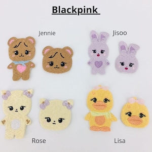 May include: Blackpink embroidered patches featuring various cartoon characters: a brown bear, a purple bunny, a yellow duck, and a white bear. The patches are labeled with the names Jennie, Jisoo, Lisa, and Rose.