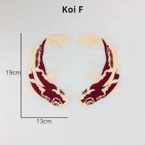 May include: Two embroidered koi fish patches in red, white, and cream colours. The fish are facing each other and are 19 cm tall and 13 cm wide.