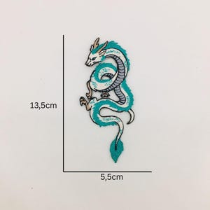 May include: Embroidered patch with a teal and white dragon design. The dragon is in a winding pose with detailed embroidery. The patch measures approximately 13.5cm high and 5.5cm wide.