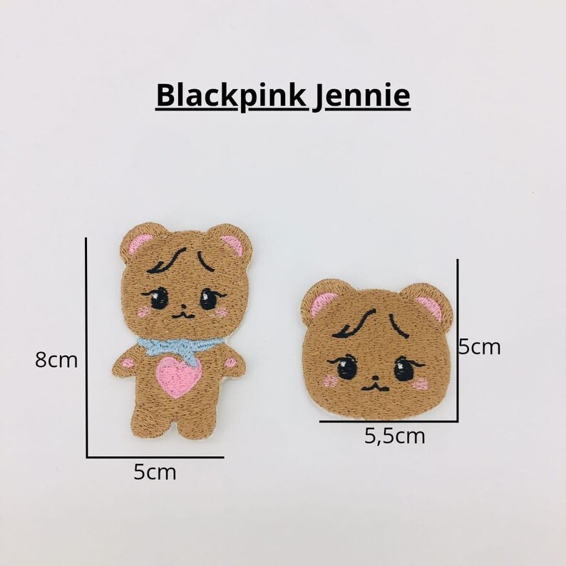 May include: Two brown embroidered iron-on patches featuring a cartoon bear. The larger patch is 8 cm tall and 5 cm wide. The smaller patch is 5.5 cm wide and 5 cm tall. The text "Blackpink Jennie" is printed above the patches.