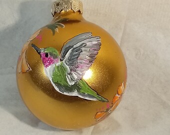 Hummingbird ornament -- everyone's favorite little bird.  Hand painted bird on round  gold glass ornament; direct from artist.