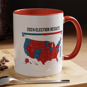 May include: White coffee mug with a red rim and handle. The mug features a map of the United States with states colored red and blue. The text "2024 Election Results" is printed above the map.