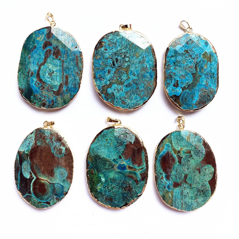 May include: Six oval-shaped pendants with a gold rim and a blue and brown agate stone. The stones have a unique marbled pattern.