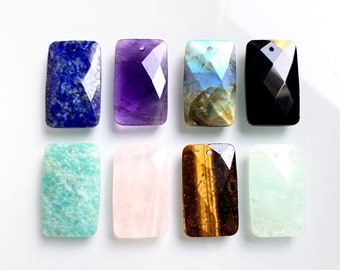 May include: Eight rectangular gemstone pendants with faceted edges and a hole at the top for stringing. The stones are amethyst, black onyx, aventurine, labradorite, rose quartz, tiger's eye, and two shades of green.