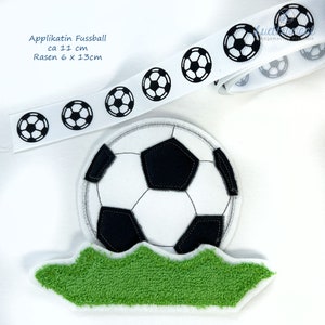 May include: Black and white soccer ball applique with green grass, measuring approximately 11 inches in diameter and 6 by 13 inches for the grass. The text "Applikatin Fussball ca 11 cm Rasen 6 x 13cm" is visible in the image.