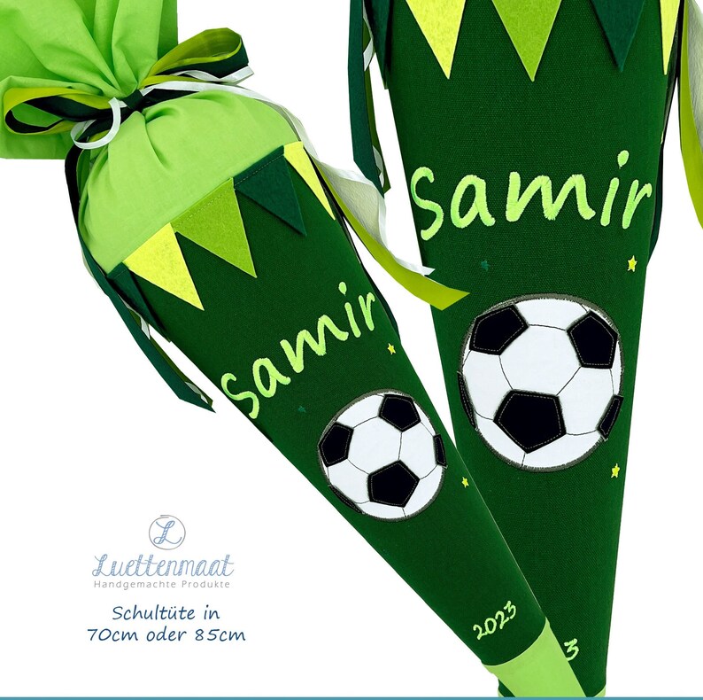 May include: Two green and yellow school cones with a soccer ball design. The cones are personalized with the name "Samir" and the year "2023".