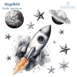 Könnte beinhalten: Bügelbild mit einer Rakete, einem Planeten und Sternen in Schwarzweiß. Der Text "Bügelbild" und "Größe 16x16cm" ist auf dem Blatt gedruckt.